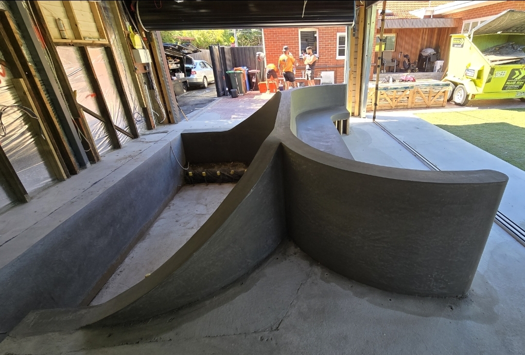 Custom architectural concrete feature wall and curved bench seating, Melbourne